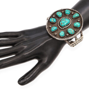 Vintage Navajo large turquoise cluster sterling silver cuff bracelet with multiple natural turquoise stones in an ornate round setting, heavyweight 94.1 gram piece shown on white background.