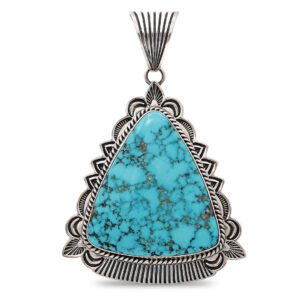 Large triangular turquoise pendant in sterling silver with ornate stamped setting on a black display bust, showcasing vibrant natural turquoise stone and Auak hallmark craftsmanship.