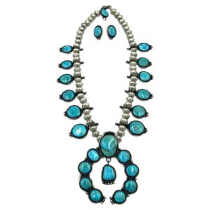 Authentic Navajo Tommy Jackson squash blossom necklace and matching earrings set with turquoise stones in sterling silver, featuring classic blossom motifs and large central naja pendant.