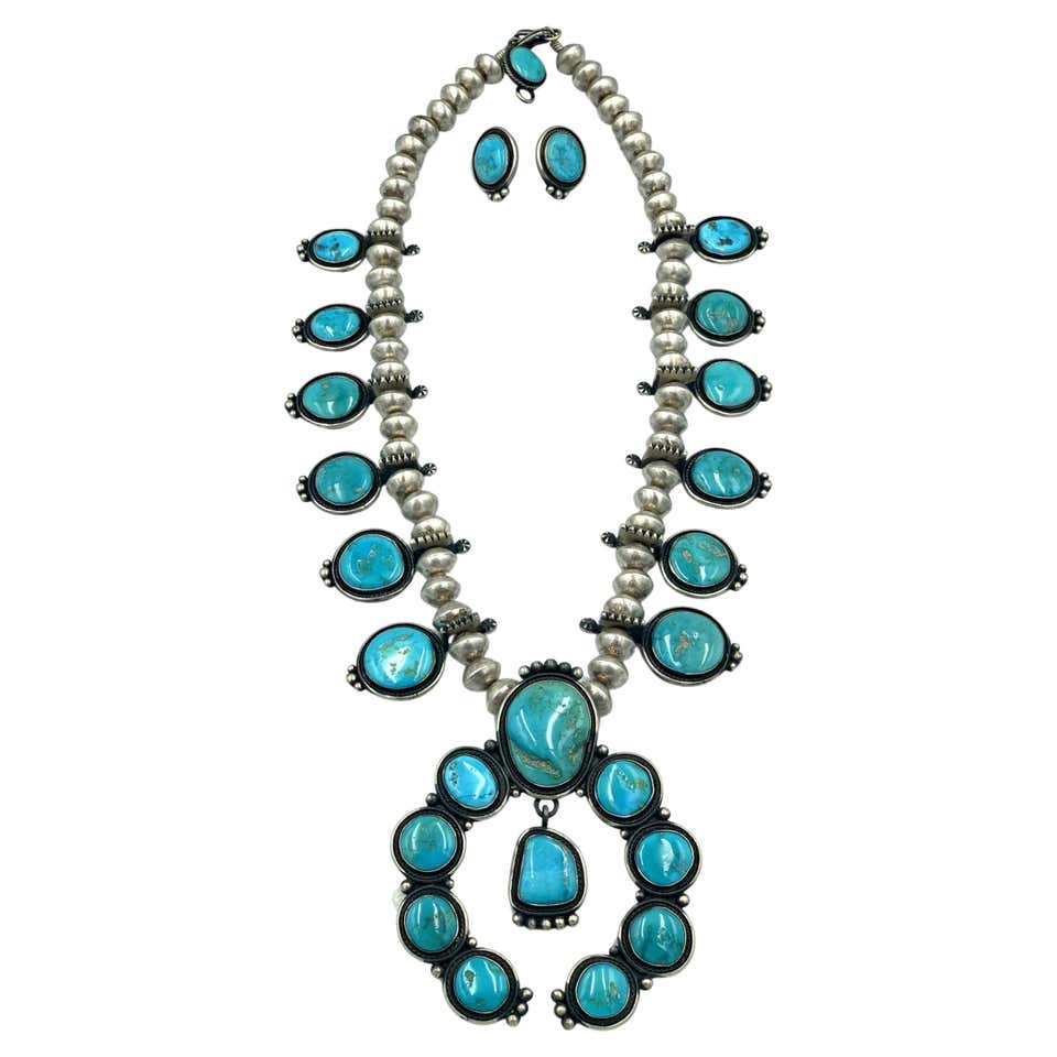 Authentic Navajo Tommy Jackson squash blossom necklace and matching earrings set with turquoise stones in sterling silver, featuring classic blossom motifs and large central naja pendant.